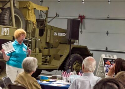 2026 At Ease Event: Carol called the door prize numbers.