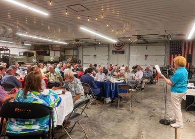 2026 At Ease Event: Carol gives the Trivia answers.