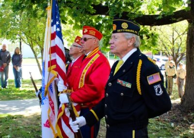 honor guard present colors as scouts and visitors look on.